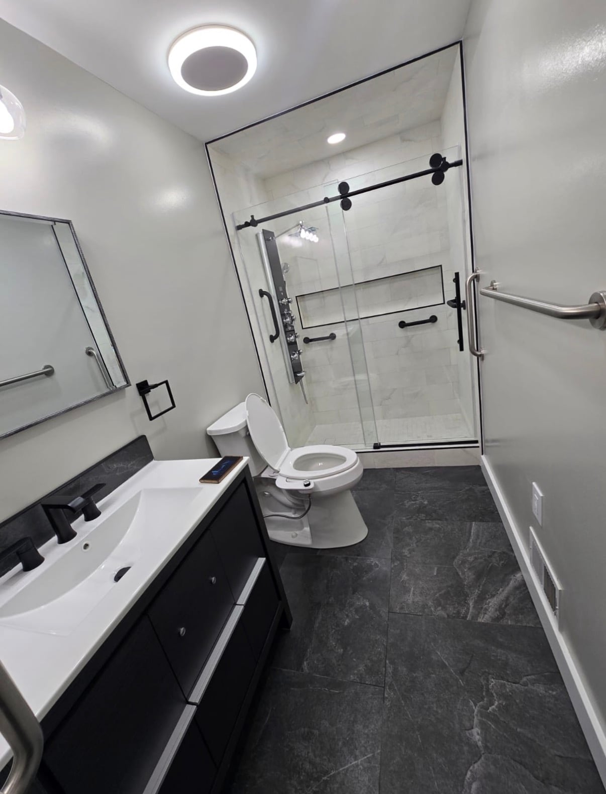 Mission Accomplished Construction measuring a bathroom during a free in-home consultation in Burlington County NJ